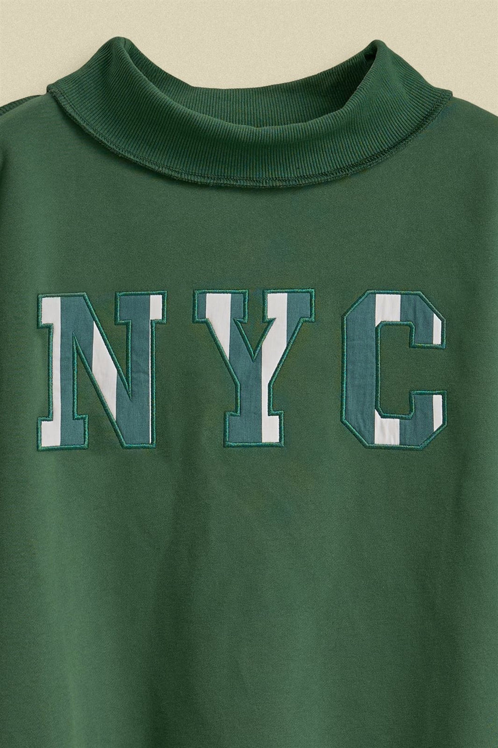 NYC Varsity Patch Mock Neck Sweatshirt with Exposed Seams in Green - Women's Wholesale Shorts | Trend Notes