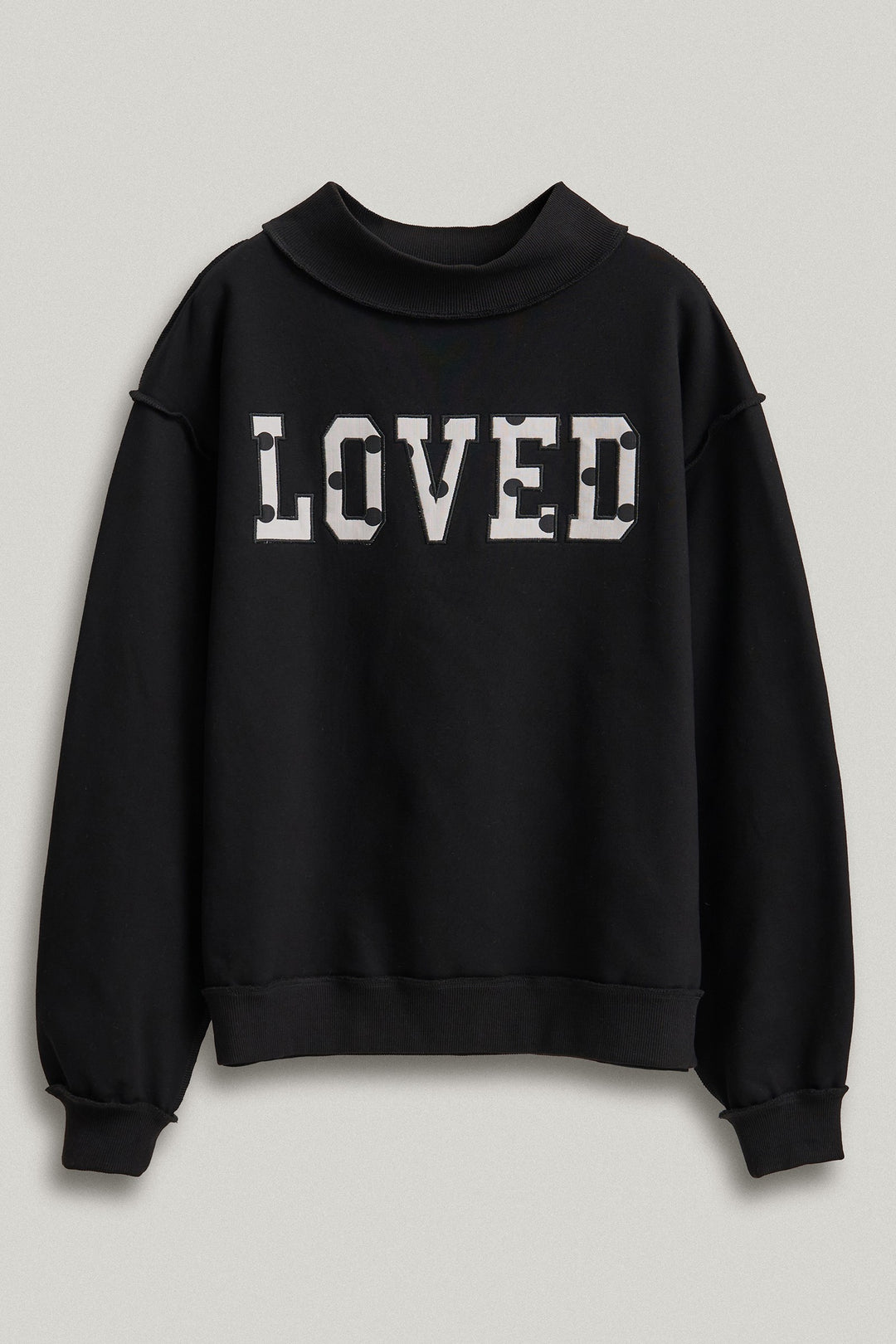 LOVED Varsity Patch Mock Neck Sweatshirt with Exposed Seams in Black - Women's Wholesale Shorts | Trend Notes