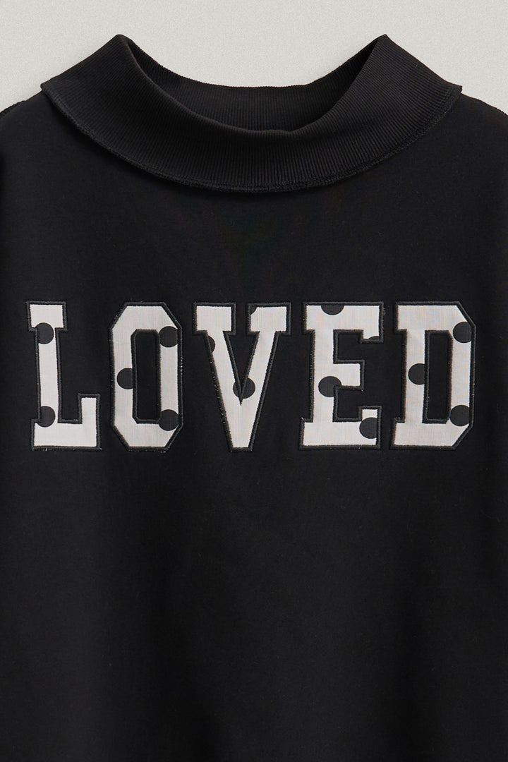LOVED Varsity Patch Mock Neck Sweatshirt with Exposed Seams in Black - Women's Wholesale Shorts | Trend Notes